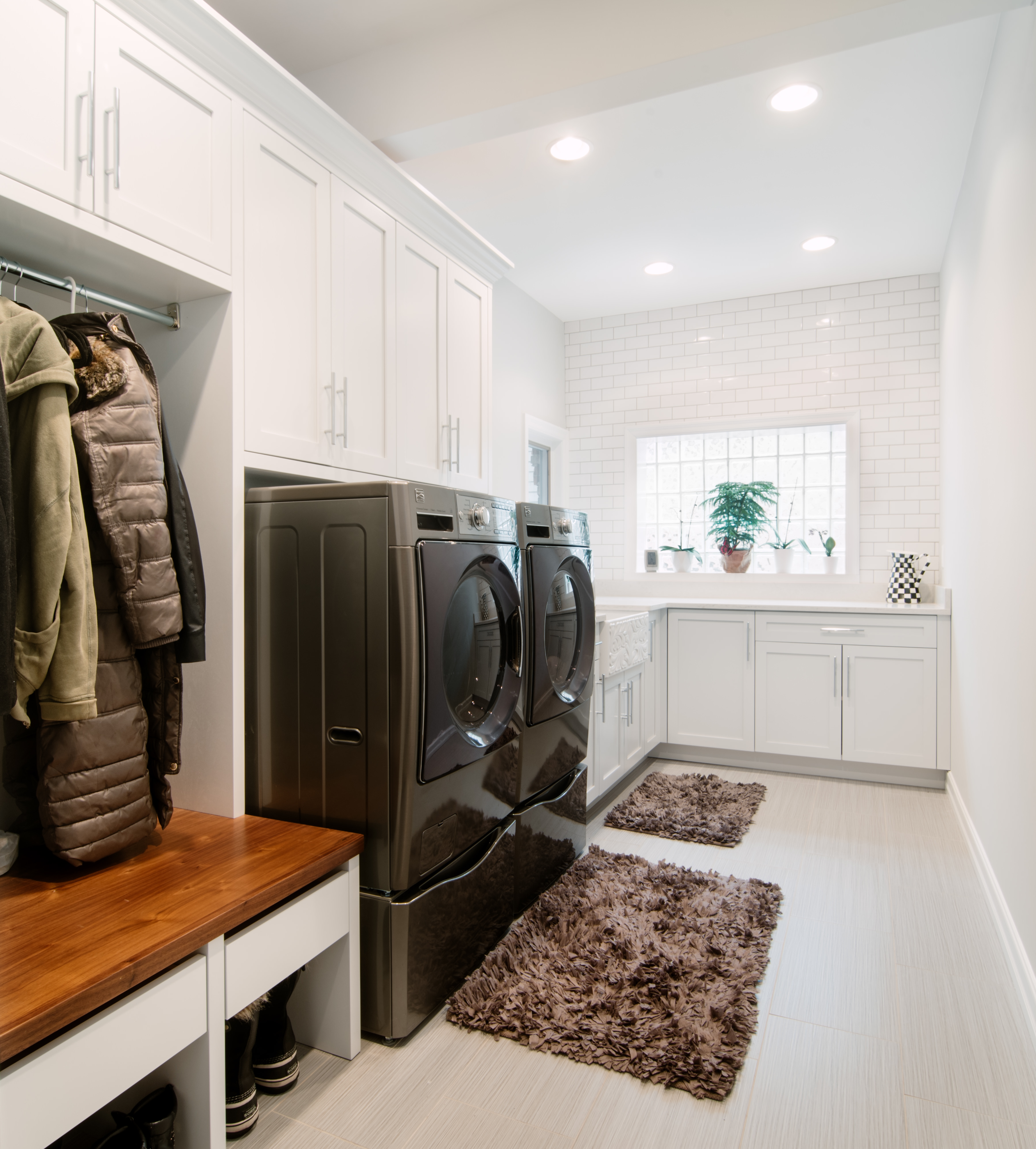 Laundry Room And Mudroom Combo Labra Design Build Sunken laundry room and mudroom combo feature gray cabinets with brass pull and a vintage wall mount sink faucet beside a subway tiled dog tub. http labradesignbuild com portfolio laundry room mudroom combo